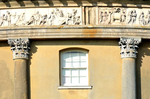 Detail of neo-classical building with olympic frieze