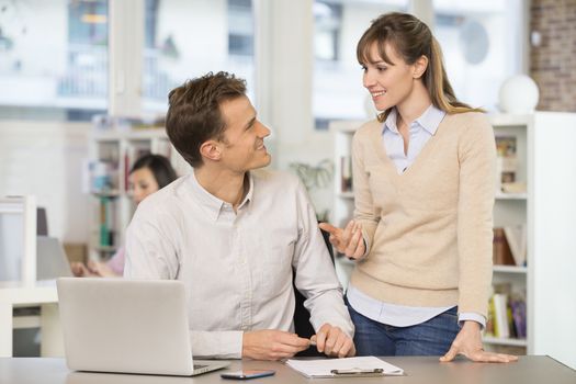 Businesswoman businessman cheerful desk speak