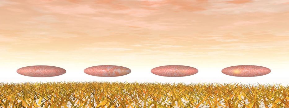 Four pebbles upon grass in pink background