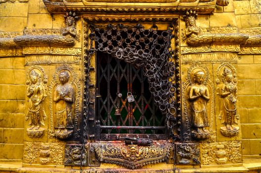 Detail of golden statues in buddhist and hindu temple, Kathmandu, Nepal