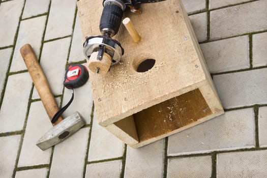 Making a birdhouse from wooden boards spring season