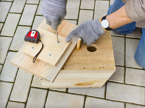 Making a birdhouse from wooden boards spring season