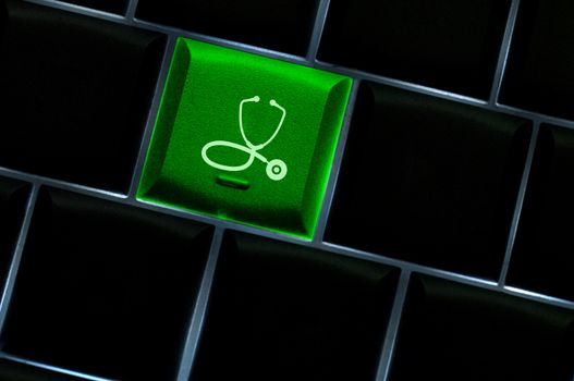 Medical stethoscope on laptop keyboard