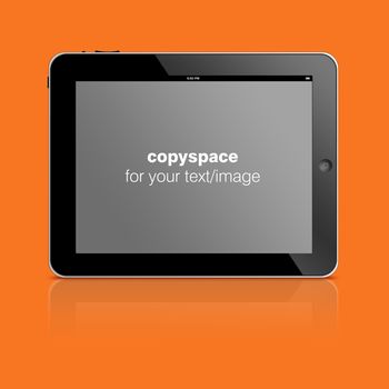 Tablet computer with copy space to add your text or photo isolated on orange background.