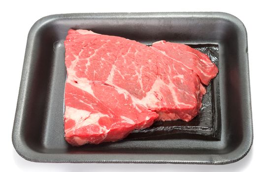 Raw beef in supermarket black foam tray on white background