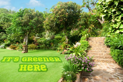 Natural stone landscaping in home garden with stairs during summer time