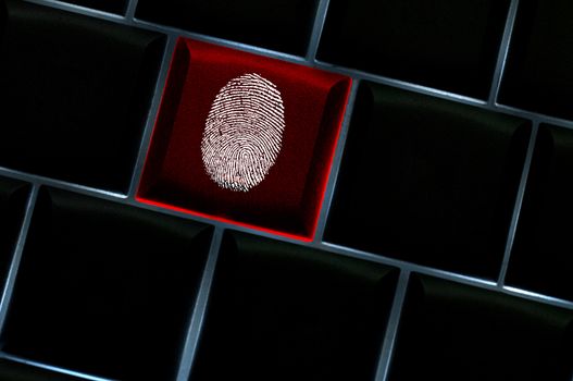 Online crime scene concept with the fingerprint left on a backlit keyboard