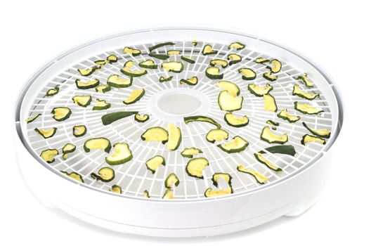 Dehydrated cucumber slices on food dehydrator tray