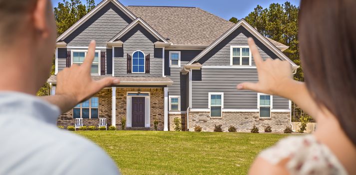 House and Military Couple Framing Hands in Front Yard.