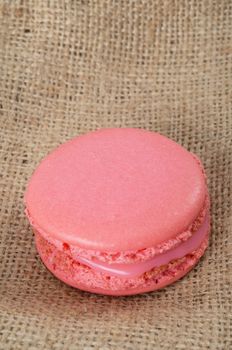 Homemade Pink macaroon on brown  fabric background