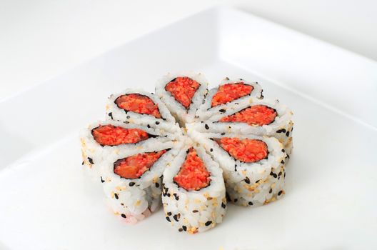 Sushi nicely decorated forming hearts  shapes on white square dish