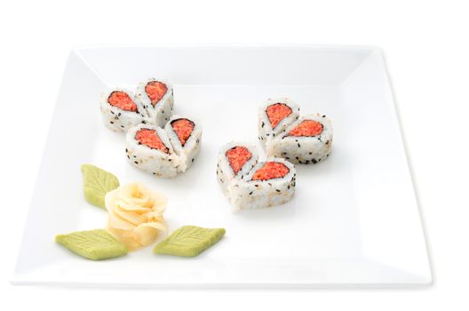 Sushi nicely decorated forming hearts  shapes on white square dish