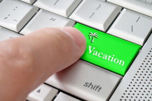 Business concept male finger pressing vacation enter key on metallic keyboard