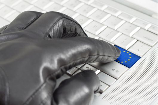 Hacking Europe concept with hand wearing black leather glove pressing enter key with flag overlaid