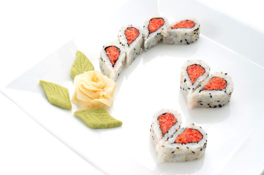 Sushi nicely decorated forming hearts  shapes on white square dish