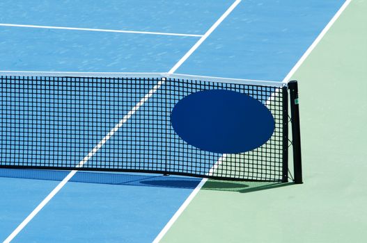 Outdoor tennis court focus on the net