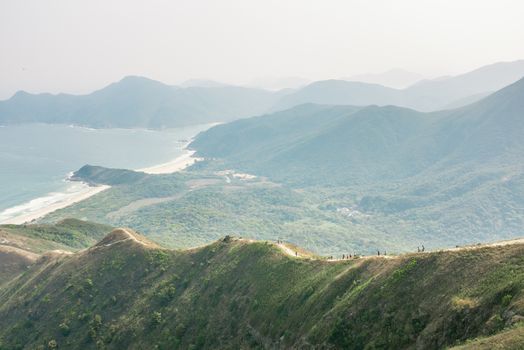 Foggy sense of a group of people walking down hill, asia