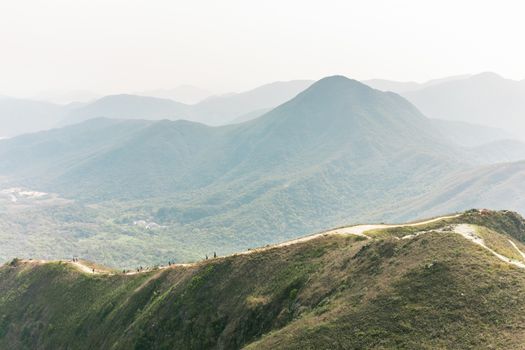 Foggy sense of a group of people walking down hill, asia