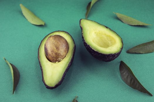 Black Ripe Avocados with leaves.