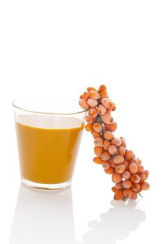 Sea buckthorn juice and fresh berries isolated on white background. Natural detox, healthy fruit eating.