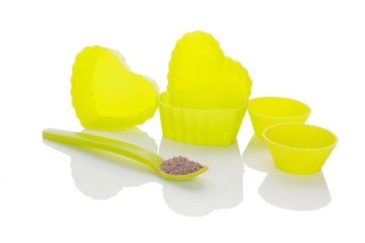 Neon hear shaped baking forms and chocolate cookie mixture isolated on white background. Baking.