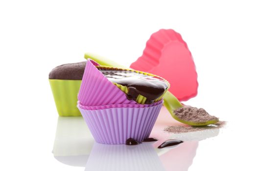 Cupcake chocolate mixture in neon colored baking forms isolated on white background. Culinary cupcakes baking.