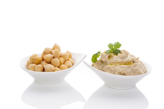 Chickpeas and hummus in bowls isolated on white background. Culinary eastern cuisine. 