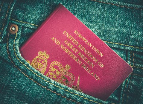 Retro Styled Photo Of British Passport In Worn Jeans Pocket