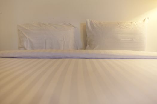 Twin white pillow on bed