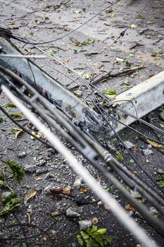 A Electric and telephone pole leans after damage from a storm.