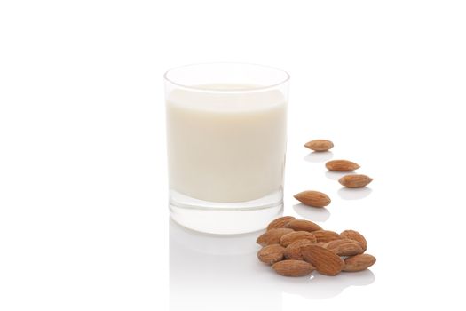 Almond milk in glass with almond nuts isolated on white background. Vegan and vegetarian milk concept.