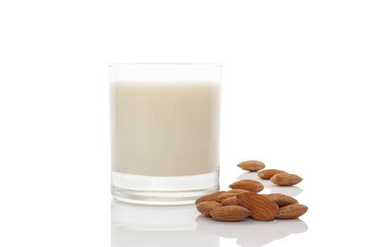 Almond milk in glass with almond nuts  isolated on white. Vegan and vegetarian eating.