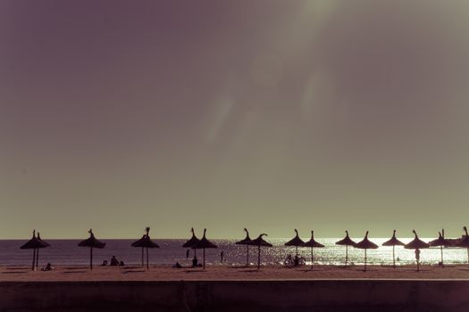 Torching sun. Sun phenomenon "fotons" pouring down from the sky on beach in the Mediterranean.