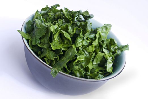 fresh spinach in a nice bowl on white background