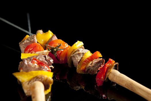 Barbeque sticks with meat, vegetables and corn