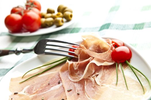 delicious Prosciutto plate with olives, tomatos.
