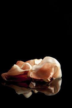 prosciutto on black background