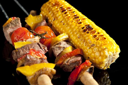Barbeque sticks with meat, vegetables and corn
