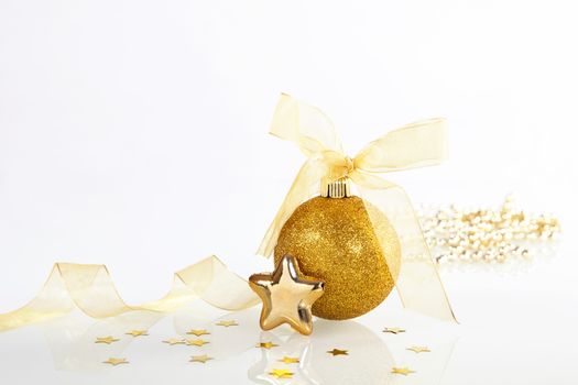 Golden shiny christmas decoration on white background.