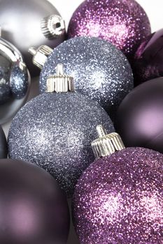Purple and silver christmas ball background. Festive shiny xmas decoration.