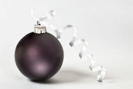 Christmas ball with ribbon on white background.