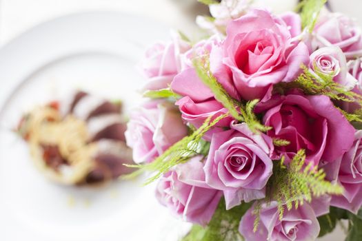 Pink rose flower on front of Beef medallions