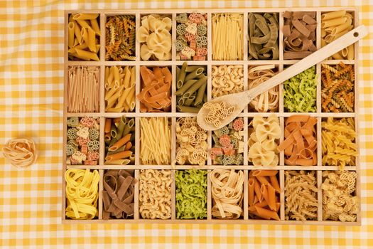 Various pasta sorts in wooden box.  Tagliatelle noodle still life.