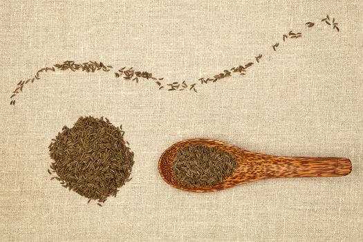 Cumin seeds decorative arranged on brown background.