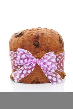 Delicious luxurious panettone fruit cake with purple bow isolated on white background. Culinary sweet dessert.