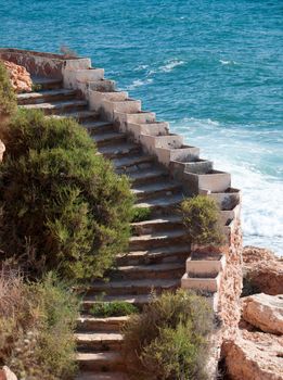 Stone staircase by the Mediterranean sea, close, La Zenia, Costa Blanca, Spain.