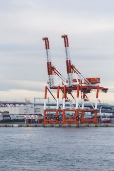 Container stacks and crane in shipyard at sunset for cargo Goods and Logistic background
