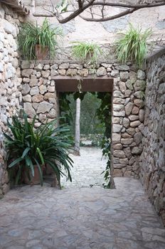 Dry stone wall portal with plants, rural Majorca. Balearic islands, Spain.