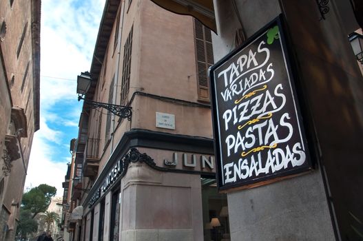 City view and an advertising text on chalkboard in a tapas bar in Palma de Mallorca, Balearic islands, Spain.