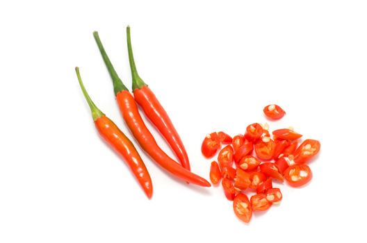 red chili peppers with small slices on white background